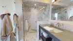 Marble walk-in shower with glass door